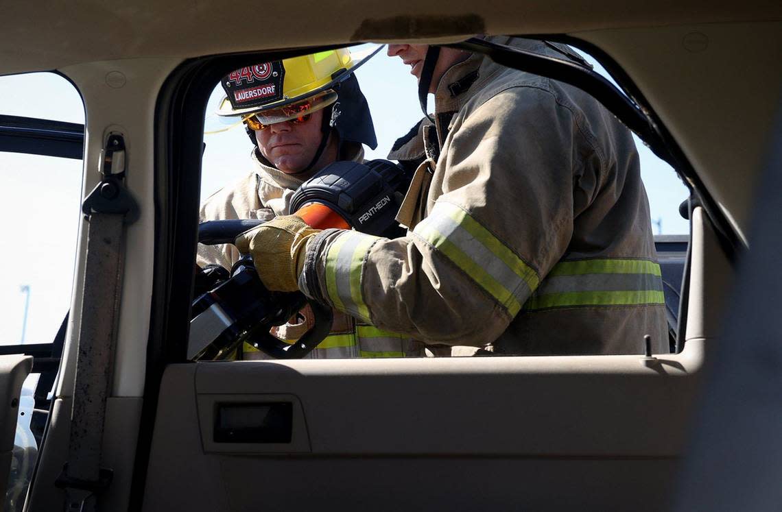 Fort Worth District 4 City Councilmember Charles Lauersdorf learns how to use a tool for extracting victims from vehicles on Friday. City officials were invited to participate in a training session to learn what firefighters face on a day-to-day basis. Amanda McCoy/amccoy@star-telegram.com