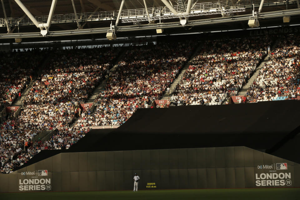 FILE - Fans watch a baseball game between the Boston Red Sox and the New York Yankees, on June 29, 2019, in London. The baseball field being installed at London Stadium will be slightly bigger than the one in 2019. The St. Louis Cardinals and Chicago Cubs will play two games at the home of Premier League club West Ham next weekend. (AP Photo/Tim Ireland, File)