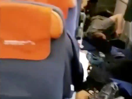 A still image from video shows passengers lying on floor and debris in plane cabin onboard an Aeroflot Boeing 777 flight from Moscow to Bangkok after it hit turbulence, May 1, 2017. MANDATORY CREDIT Provided by RR/Rostik Rusev/Handout via Reuters TV