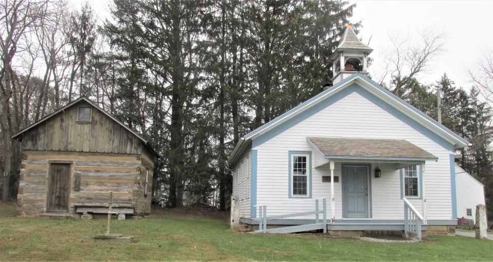 The marker building to the left and Peter's School were built in the 1800s and later refurbished and relocated to Heritage Park in Winesburg.