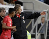 Peru's coach Ricardo Gareca, right, talks to Anderson Santamaria during a friendly soccer match between Germany and Peru in Sinsheim, Germany, Sunday, Sept. 9, 2018. (AP Photo/Michael Probst)