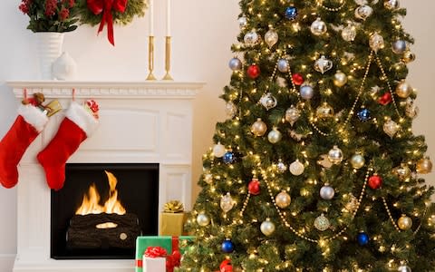 Christmas tree next to a fire - Credit: Getty