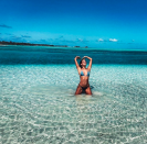 <p>The Portugal-native model cools off in the ocean and poses for a selfie. Those abs are everything.</p>