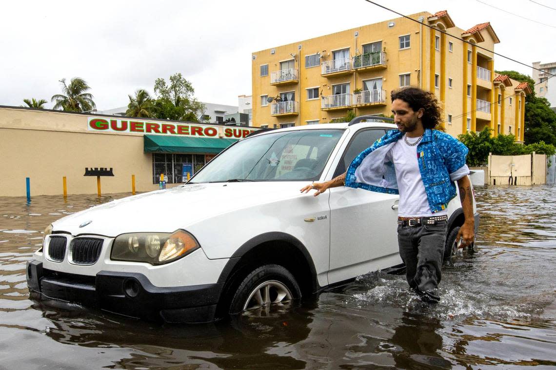 Gabe Gomez, 30, walks through the knee-high floodwater after his car broke down outside of Guerrero Market near Southwest Fourth Street and Eighth Avenue in the Little Havana neighborhood of Miami, Florida, on Saturday, June 4, 2022. Daniel A. Varela/dvarela@miamiherald.com