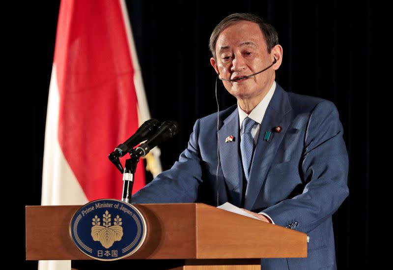 Japanese PM Suga speaks to the media during a press conference in Jakarta