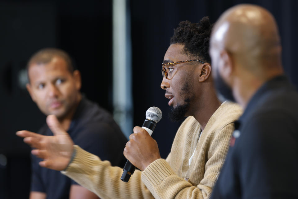 Cleveland Cavaliers guard Donovan Mitchell, center, answers a question as president of basketball operations Koby Altman, left, and head coach J.B. Bickerstaff look on during an NBA basketball news conference, Wednesday, Sept. 14, 2022, in Cleveland. (AP Photo/Ron Schwane)