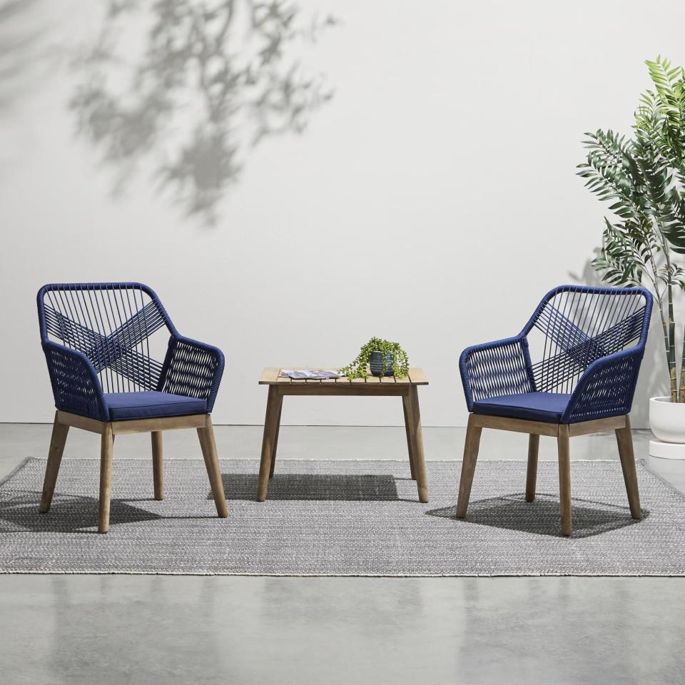 the three-piece furniture set with a table and two matching chairs on a patio