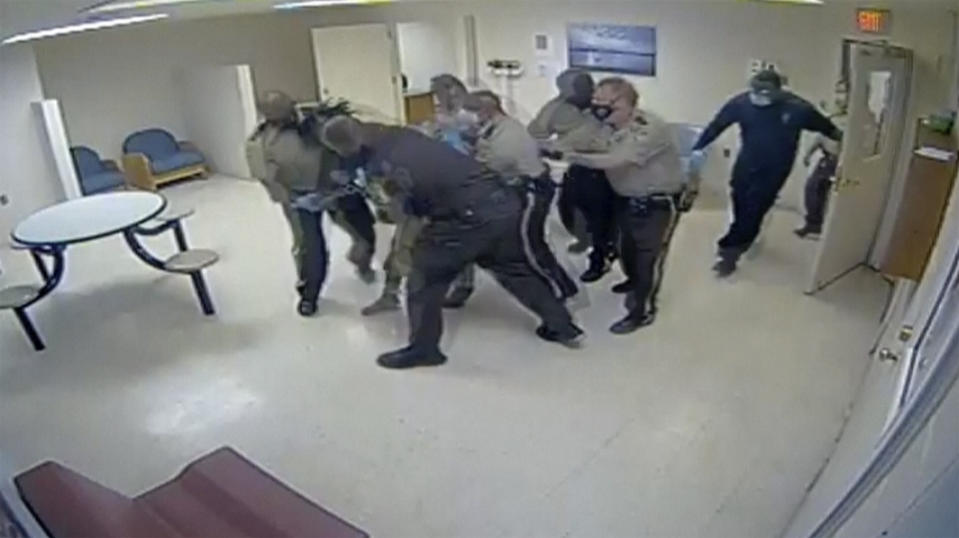 This video provided by Central State Hospital/Dinwiddie County, Va. shows a clip from surveillance camera of deputies and hospital employees carrying Irvo Otieno into the room at Central State Hospital, on March 6, 2023 in Petersburg, Va. Footage obtained Tuesday, March 21, which has no audio, shows various members of sheriff's deputies and employees attempting to restrain a handcuffed and shackled Otieno for about 20 minutes after he's led into a room at the hospital, where he was going to be admitted. (Central State Hospital/Dinwiddie County, Va. Attorney via AP)