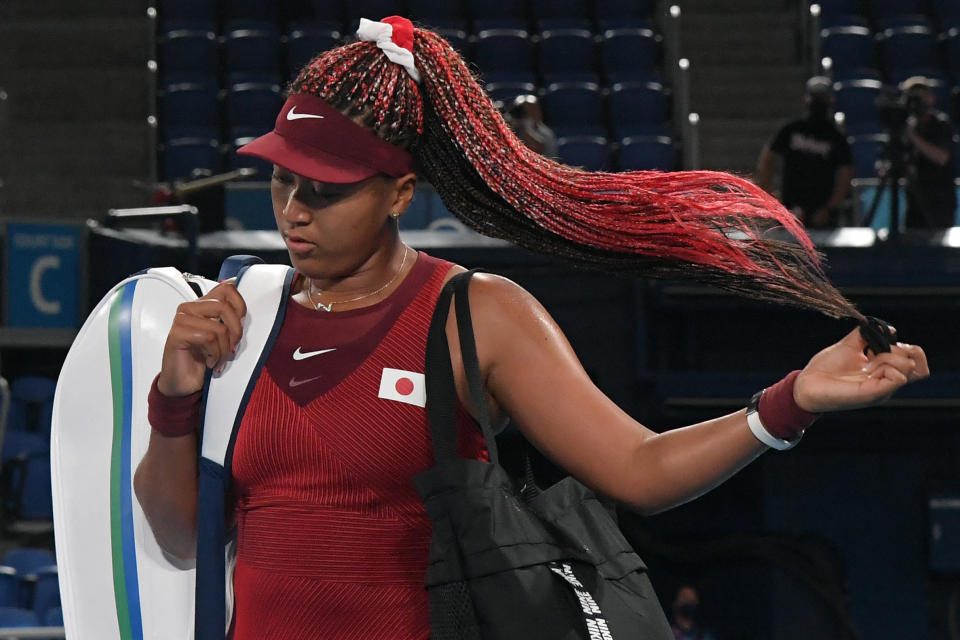 Japan's Naomi Osaka leaves the court after being beaten by Czech Republic's Marketa Vondrousova in their Tokyo 2020 Olympic Games women's singles third round tennis match at the Ariake Tennis Park in Tokyo on July 27, 2021. (Photo by Tiziana FABI / AFP) (Photo by TIZIANA FABI/AFP via Getty Images)