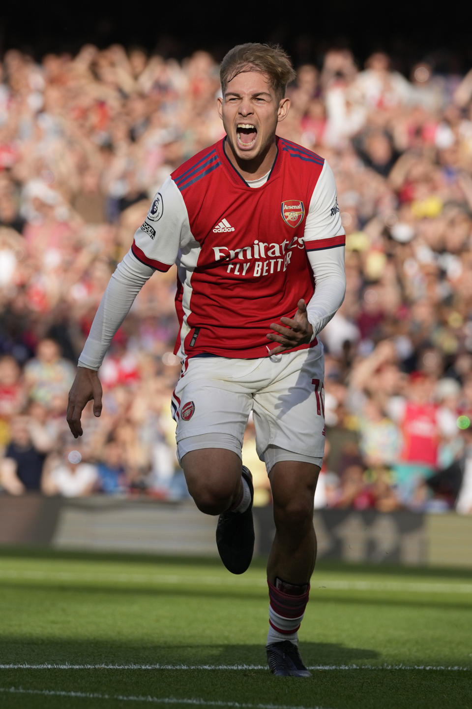 Arsenal's Emile Smith Rowe celebrates after scoring his side's opening goal during the English Premier League soccer match between Arsenal and Tottenham Hotspur at the Emirates stadium in London, Sunday, Sept. 26, 2021. (AP Photo/Frank Augstein)