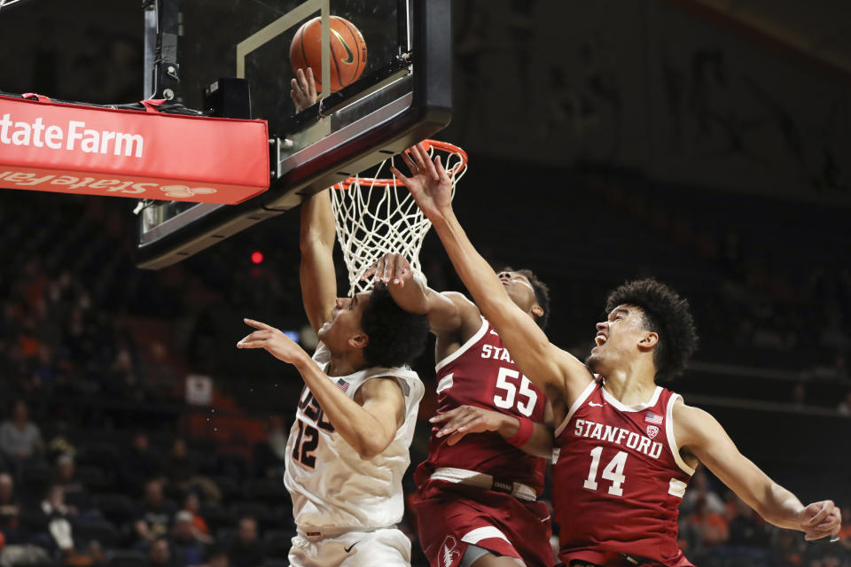 Stanford's Harrison Ingram (55) and Spencer Jones (14) try to block a shot by Oregon State forward Michael Rataj (12) during the first half of an NCAA college basketball game in Corvallis, Ore., Thursday, March 2, 2023. (AP Photo/Amanda Loman)