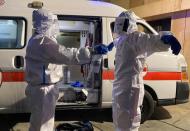 A volunteer from Lebanese Red Cross sanitizes his colleague at LAU Medical Center – Rizk Hospital in Beirut