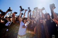 <p>Photojournalists with their eyes blindfolded raise their cameras to protest the closing of the DyN news agency, outside the National Congress in Buenos Aires, Argentina. DyN is the latest in a series of closures of news outlets in Argentina that have left over 2,000 workers unemployed. (AP Photo/Victor R. Caivano) </p>
