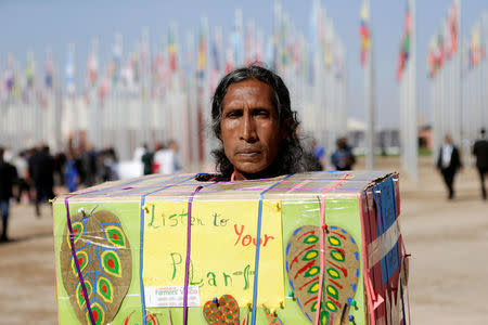 An indigenous man protests outside the UN Climate Change Conference 2016 (COP22) in Marrakech, Morocco, November 18, 2016. REUTERS/Youssef Boudlal