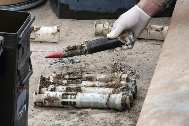 In this image provided by the U.S. Air National Guard, U.S. Air Force National Guard Explosive Ordnance Disposal Techinicians prepare several contaminated and compromised depleted uranium rounds on June 23, 2022 at Tooele Army Depot, Utah. (Staff Sgt. Nicholas Perez/U.S. Air National Guard via AP)