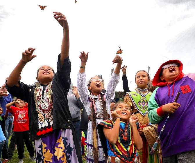 Children react as monarch butterflies are released during a past Prairie Awakening-Prairie Awoke Celebration.