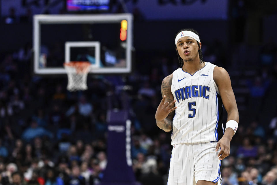 Orlando Magic forward Paolo Banchero (5) gestures during the second half of the team's NBA basketball game against the Charlotte Hornets, Tuesday, March 5, 2024, in Charlotte, N.C. (AP Photo/Matt Kelley)