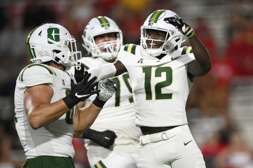 Charlotte wide receiver Jairus Mack (12) celebrates after his touchdown with tight end Jake Clemons, left, during the first half of an NCAA college football game against Maryland, Saturday, Sept. 9, 2023, in College Park, Md. (AP Photo/Nick Wass)