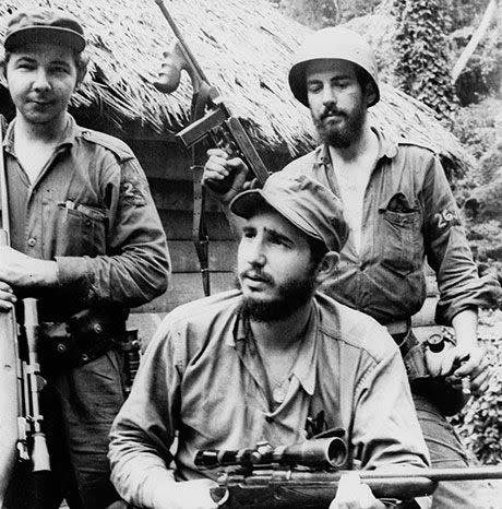 In this March 14, 1957 file photo, Fidel Castro, the young anti-Batista guerrilla leader, center, is seen with his brother Raul Castro, left, and Camilo Cienfuegos, right, while operating in the Mountains of Eastern Cuba. Image: AP