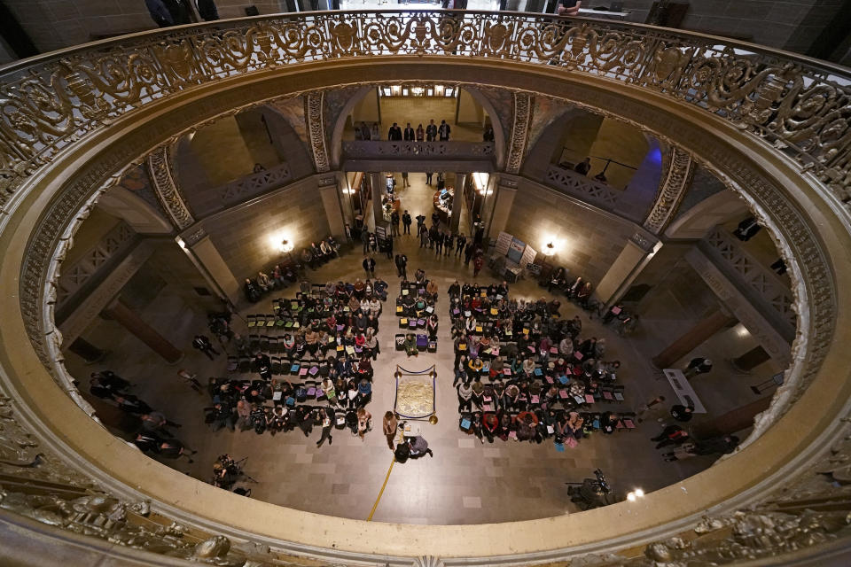 People listen to a speaker during a rally in favor of a ban on gender-affirming health care legislation, Monday, March 20, 2023, at the Missouri Statehouse in Jefferson City, Mo. (AP Photo/Charlie Riedel)