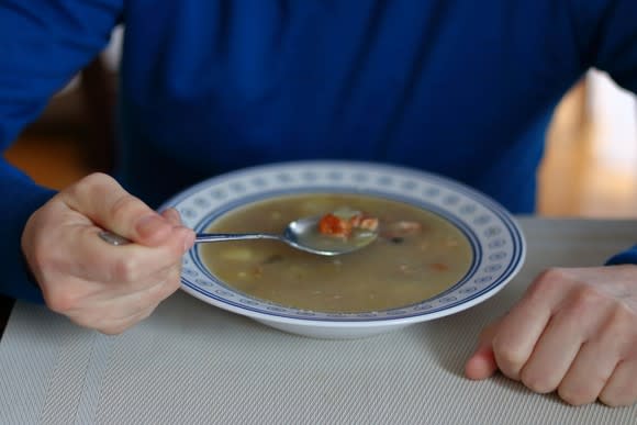 Man preparing to eat bowl of soup