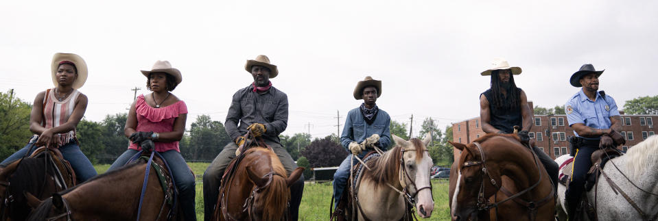 This image released by Netflix shows, from left, Ivannah-Mercedes, Lorraine Toussaint, Idris Elba, Caleb McLaughlin, Jamil "Mil" Prattis and Cliff "Method Man" Smith in a scene from "Concrete Cowboys." (Jessica Kourkounis/Netflix via AP)