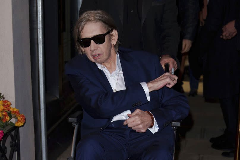 Shane MacGowan poses for photographers upon arrival at the Shane MacGowan, The Eternal Buzz & The Crock of Gold Exhibition in London, Tuesday, 11 Oct. 2022.