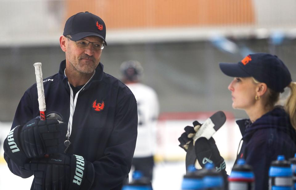 Coachella Valley Firebirds head coach Dan Bylsma, left, talks with assistant coach Jessica Campbell during practice at the Berger Foundation Iceplex in Palm Desert, Calif., Oct. 3, 2023.