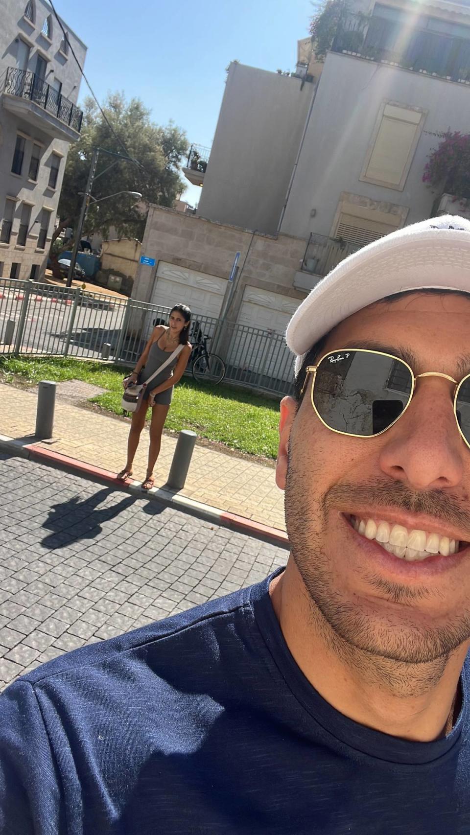 Guy Gil, a 29-year-old real estate developer from Sunny Isles Beach, was visiting his family in Tel Aviv at the time of the Hamas attacks. The woman behind him is his 22-year-old cousin, who was attending the Supernova Music Festival near the Gaza Strip on Saturday, Oct. 7, 2023, where Hamas militants killed more than 260 Israelis and took people hostage. She was injured and hospitalized. The photo was taken about 10 hours before the festival. Guy Gil