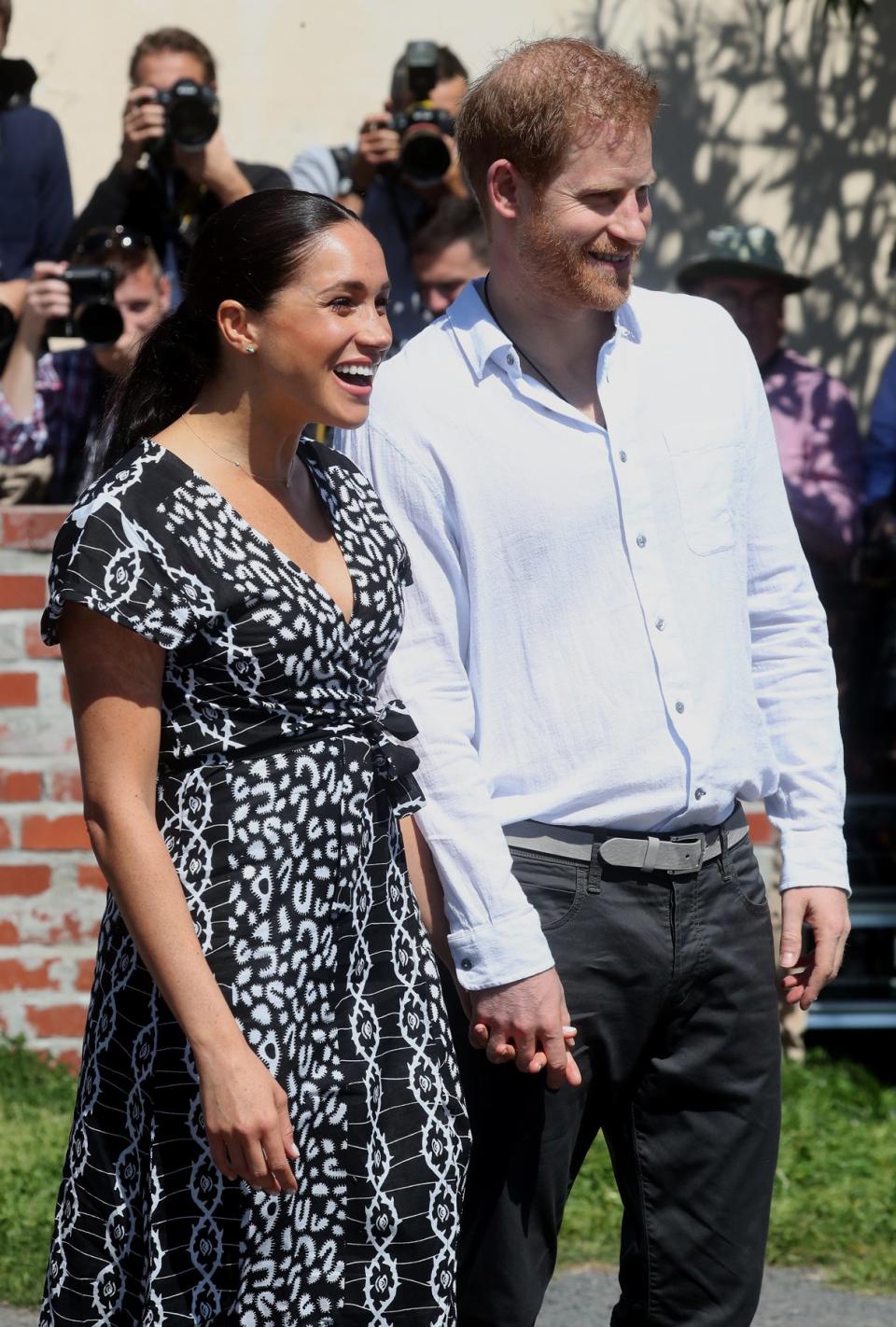 <a href="https://people.com/tag/meghan-markle/" rel="nofollow noopener" target="_blank" data-ylk="slk:Meghan Markle;elm:context_link;itc:0;sec:content-canvas" class="link ">Meghan Markle</a> and <a href="https://people.com/tag/prince-harry/" rel="nofollow noopener" target="_blank" data-ylk="slk:Prince Harry;elm:context_link;itc:0;sec:content-canvas" class="link ">Prince Harry</a> kicked off the first day of their 10-day royal tour of Africa with an outing (full of hand holding!) in Cape Town, South Africa. 