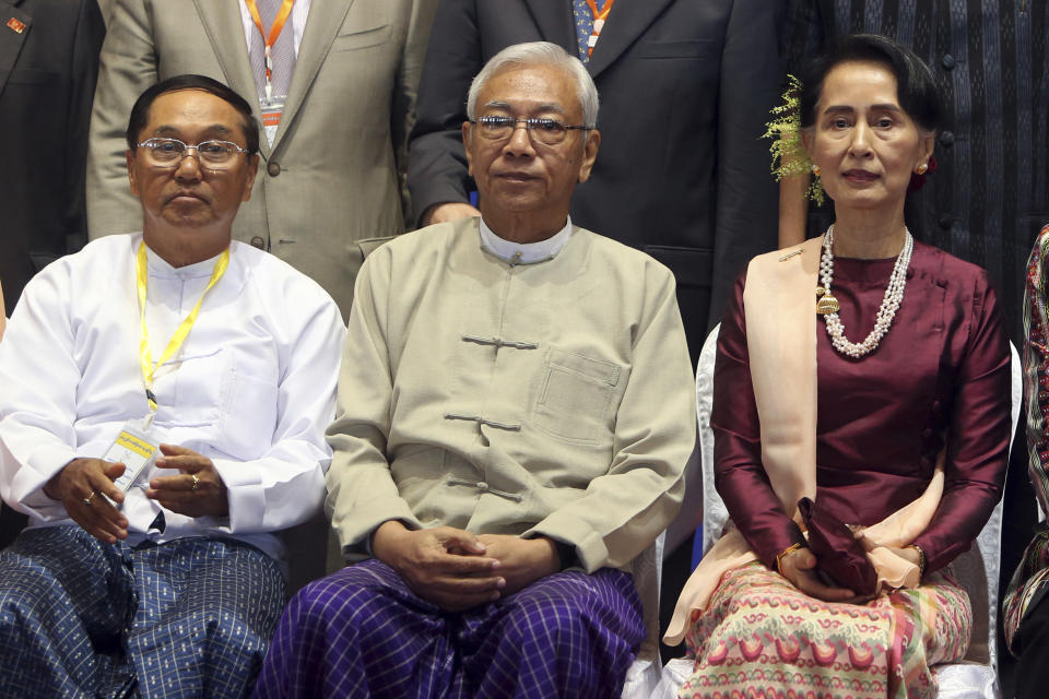 FILE - In this Oct. 15, 2017, file photo, Myanmar's Vice President Myint Swe, left, sits with State Counsellor Aung San Suu Kyi, right, and then President Htin Kyaw, for a photo session after the second anniversary of the signing of nationwide ceasefire agreement at the Myanmar International Convention Center in Naypyitaw, Myanmar. Myanmar military television said Monday, Feb. 1, 2021 that the military was taking control of the country for one year, while reports said many of the country’s senior politicians including Suu Kyi had been detained. The military TV report said Commander-in-Chief Senior Gen. Min Aung Hlaing would be in charge of the country, while Myint Swe would be elevated to acting president. (AP Photo/Aung Shine Oo, File)