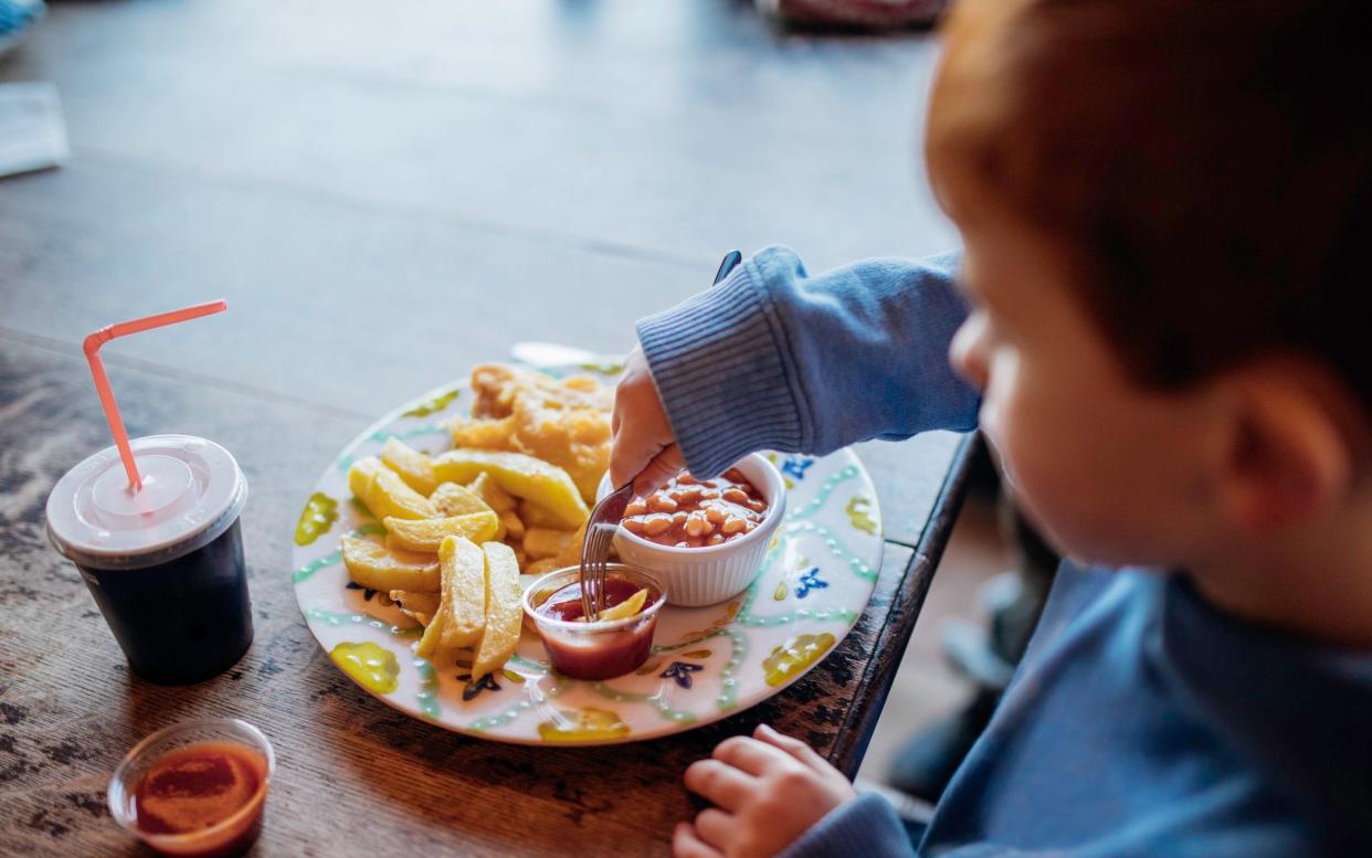 Boy eating fish and chips