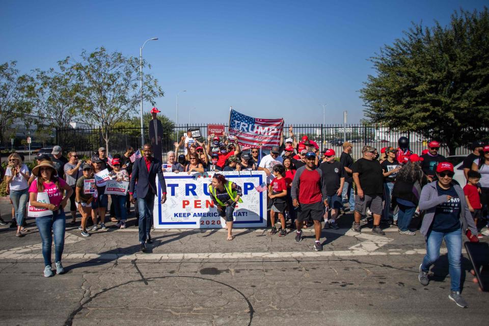 People gather before a Pro-Trump car caravan in Long Beach, CaliforniaAFP/Getty