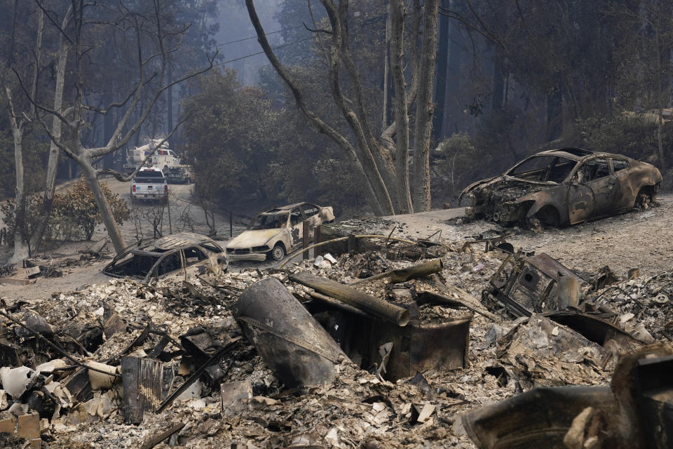 Burned vehicles and a rubble from homes are left after the CZU Lightning Complex Fire went through Sunday, Aug. 23, 2020, in Boulder Creek, Calif. (AP Photo/Marcio Jose Sanchez)