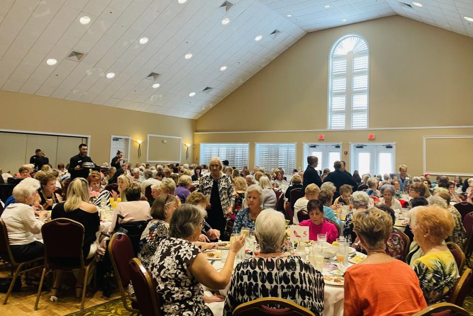 Manna rarely has to leave the retirement community. Her days are now broken up by social events like this women's luncheon, which followed a fashion show. (Courtesy Christina Manna)