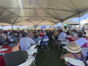 Republicans supporters gather at the seventh annual Basque Fry at the Corley Ranch on Saturday, Aug. 13, 2022, outside Gardnerville, Nev. The event, which includes live music, an inflatable rodeo ride and Basque cuisine, is modeled after Republican Nevada Senate candidate Adam Laxalt's grandfather and former Nevada governor Paul Laxalt's cookouts. The elder Laxalt was the son of Basque immigrants, and Adam now hosts the event with the Morning in Nevada PAC. (AP Photo/Gabe Stern)