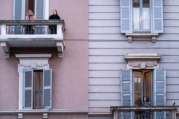 Neighbours in Porta Genova listening to music while drinking wine during the lock down. Photo: Getty Images