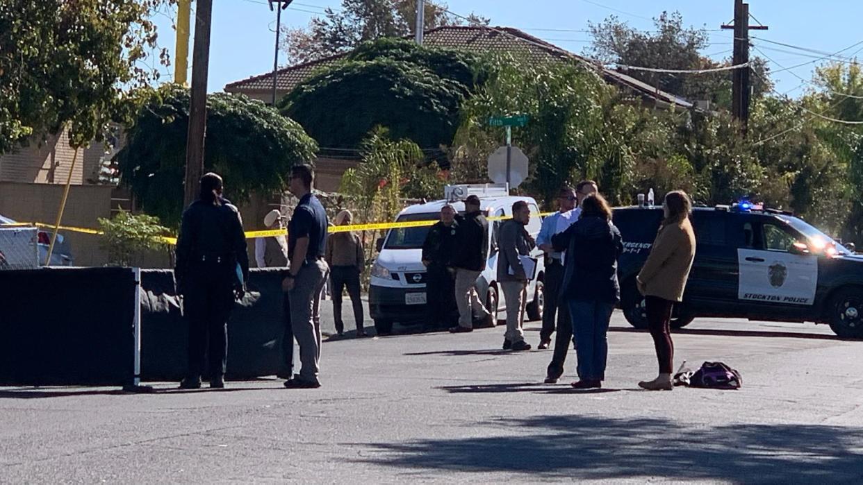 Police work the scene where a woman was found fatally stabbed inside a vehicle on Sikh Temple Street in south Stockton