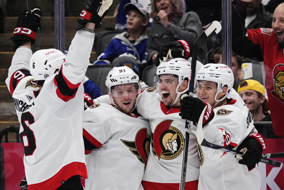 Ottawa Senators' Drake Batherson, second right, celebrates his goal against the Toronto Maple Leafs with teammates Jakob Chychrun, left to right, Vladimir Tarasenko and Tim Stutzle during the third period of an NHL hockey game, Wednesday, Dec. 27, 2023 in Toronto. (Frank Gunn/The Canadian Press via AP)