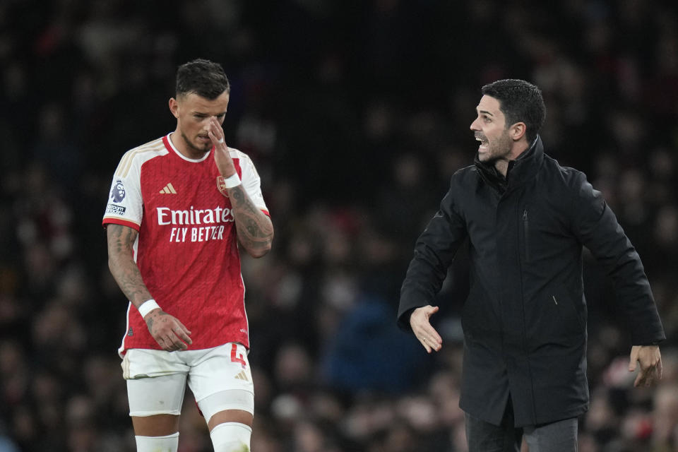 Arsenal's manager Mikel Arteta, right, and Arsenal's Ben White, left, during the English Premier League soccer match between Arsenal and West Ham at Emirates stadium in London, England, Thursday, Dec. 28, 2023. (AP Photo/Alastair Grant)