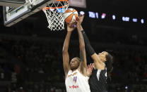 Phoenix Mercury forward Natasha Mack (4) and Las Vegas Aces center A'ja Wilson (22) fight for a rebound during the first half of an WNBA basketball game Tuesday, May 21, 2024, in Las Vegas. (Steve Marcus/Las Vegas Sun via AP)