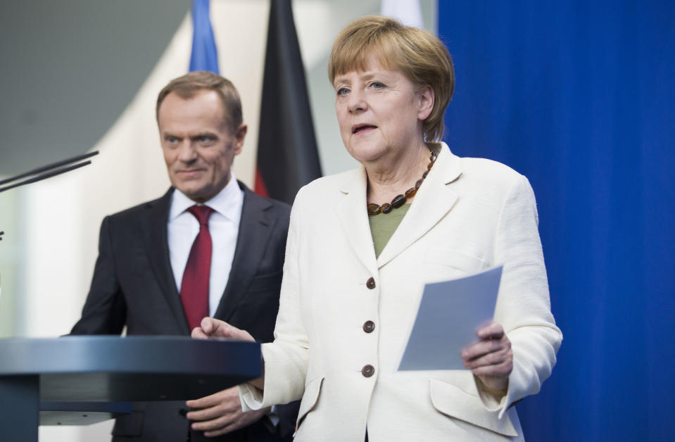 German Chancellor Angela Merkel, right, and Poland's prime minister, Donald Tusk, left, arrive for a media statement prior to talks likely to center on the situation in Ukraine at the chancellery in Berlin, Germany, Friday, April 25, 2014. (AP Photo/Gero Breloer)