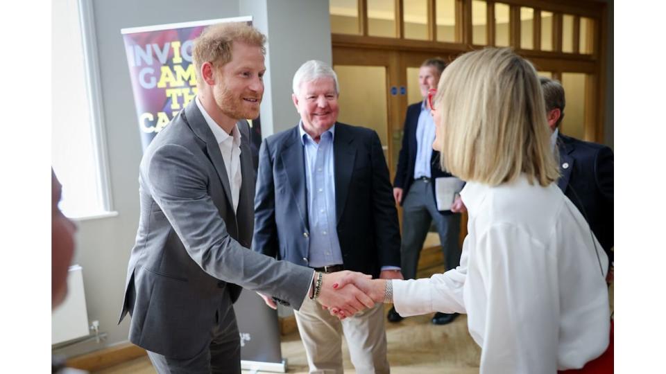 Prince Harry shaking hands with Louise Minchin