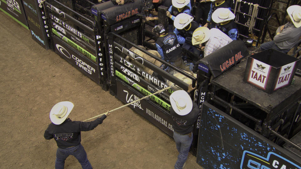 This image released by Amazon Prime Video shows a member of the Carolina Cowboys preparing to ride a bull in a scene from the series "The Ride." (Amazon Prime Video via AP)