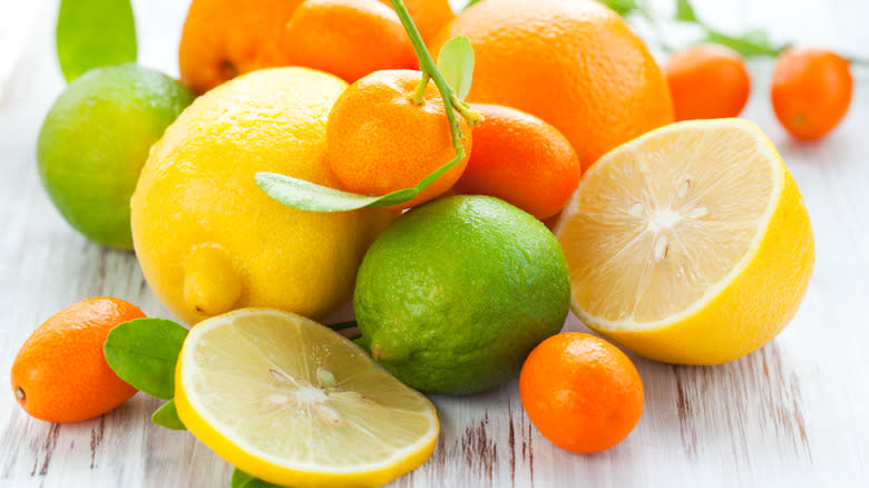 Assorted citrus fruits on wood