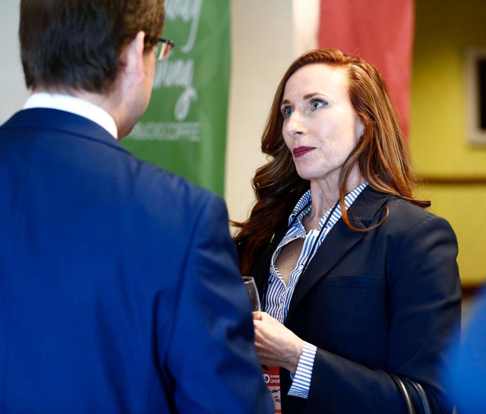 State Sen. Holly Thompson Rehder speaks with an attendee at the GOP Lincoln Day event at the Oasis Convention Center on March 9, 2024.