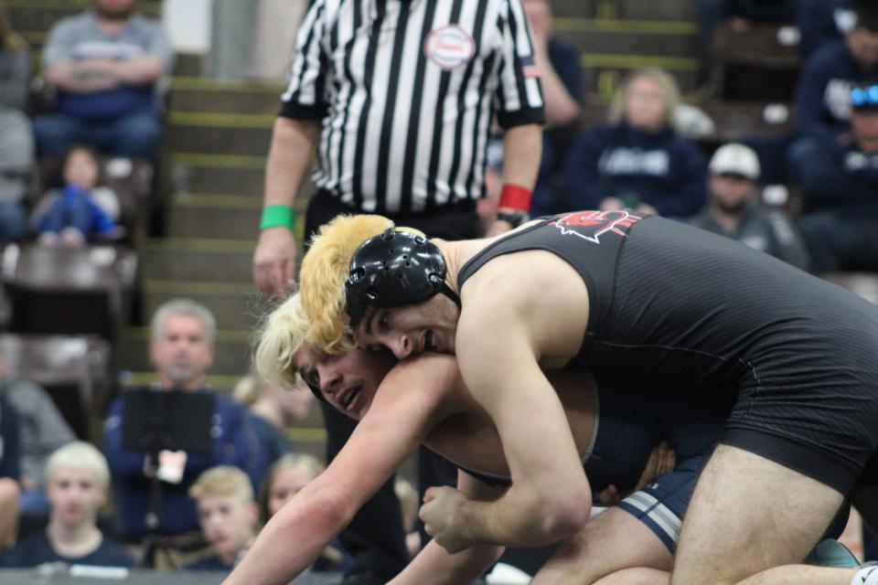 Clinton's John Keibler wrestles Yale's Kameron Soucy during the Division 3 team state quarterfinals at the Wings Event Center on Friday.