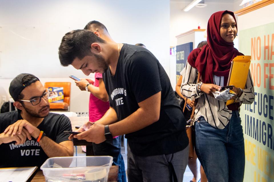 Duretti Ahmad, right, leaves to canvas with TIRRC Votes Thursday, July 11, 2019, in Nashville, Tenn.