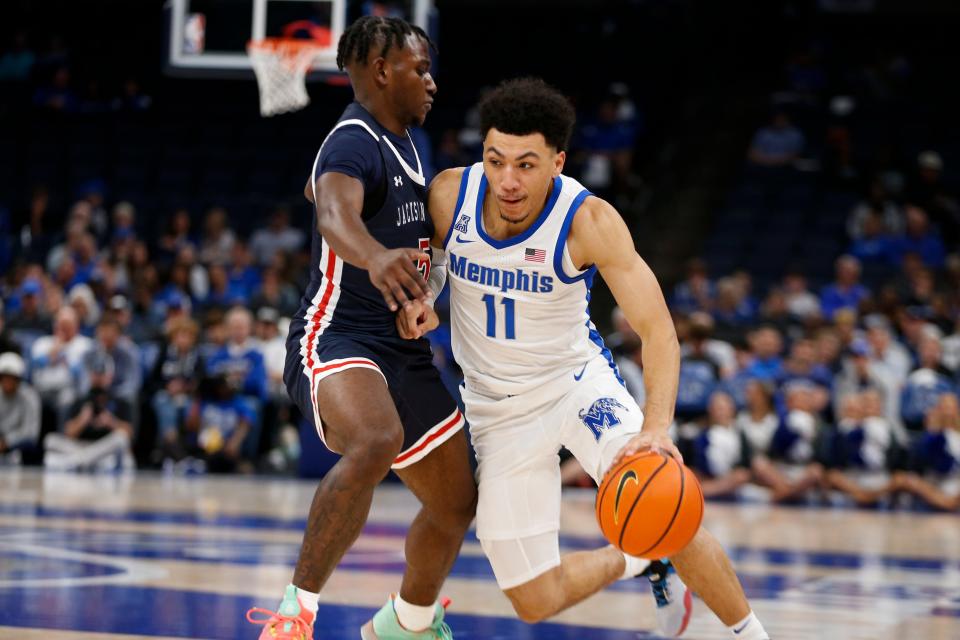 Memphis' Jahvon Quinerly (11) drives to the basket during the season opener between the University of Memphis and Jackson State University at FedExForum in Memphis, Tenn., on Monday, November 6, 2023.