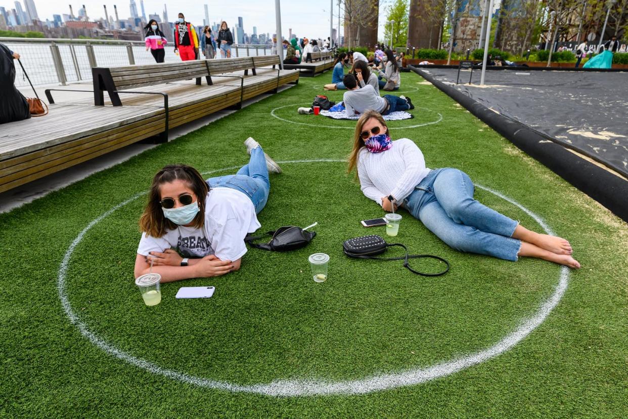 <span class="caption">Face masks and social distancing have become the norm in New York City.</span> <span class="attribution"><a class="link " href="https://www.gettyimages.com/detail/news-photo/people-practice-social-distancing-in-white-circles-in-news-photo/1225475566" rel="nofollow noopener" target="_blank" data-ylk="slk:Noam Galai/Getty Images;elm:context_link;itc:0;sec:content-canvas">Noam Galai/Getty Images</a></span>